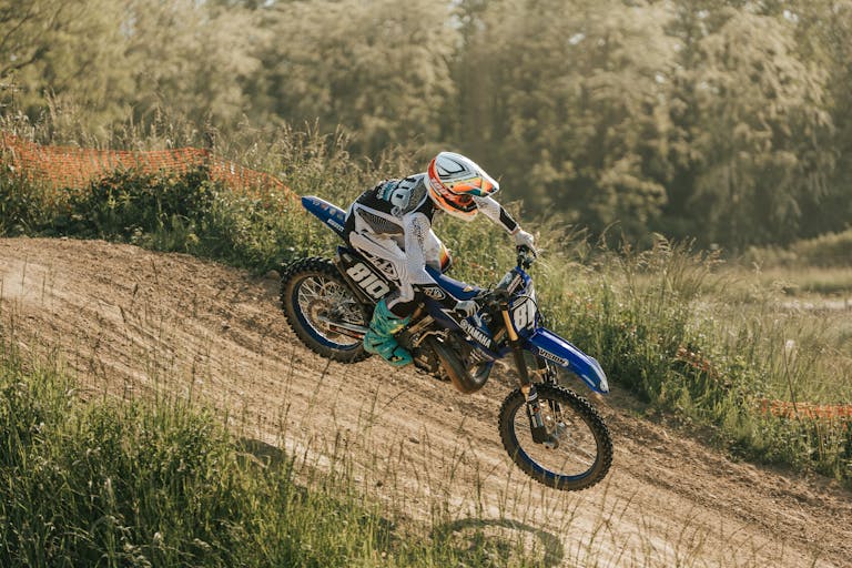 Exciting motocross rider navigating a dirt track during a race event.